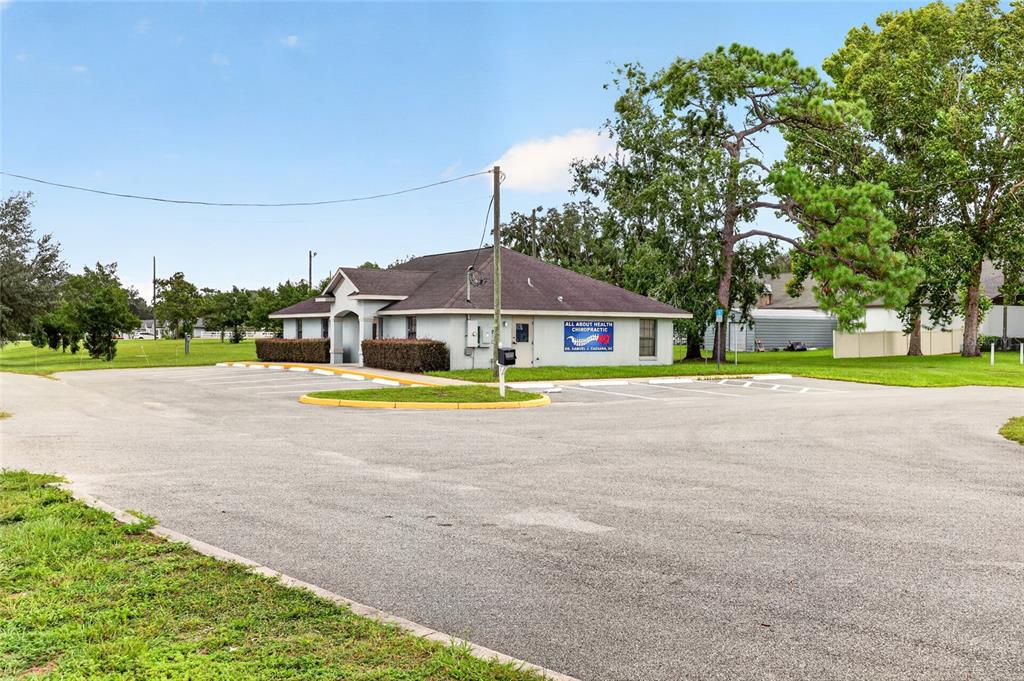 A single-story commercial building with a parking lot and a chiropractic sign — 7133 SE MARICAMP ROAD, OCALA, FL