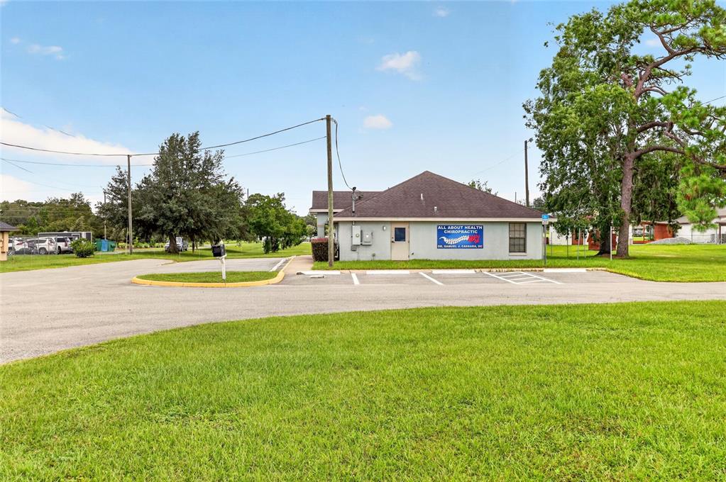 A single-story chiropractic office building sits on a paved lot with a grassy foreground — 7133 SE MARICAMP ROAD, OCALA, FL