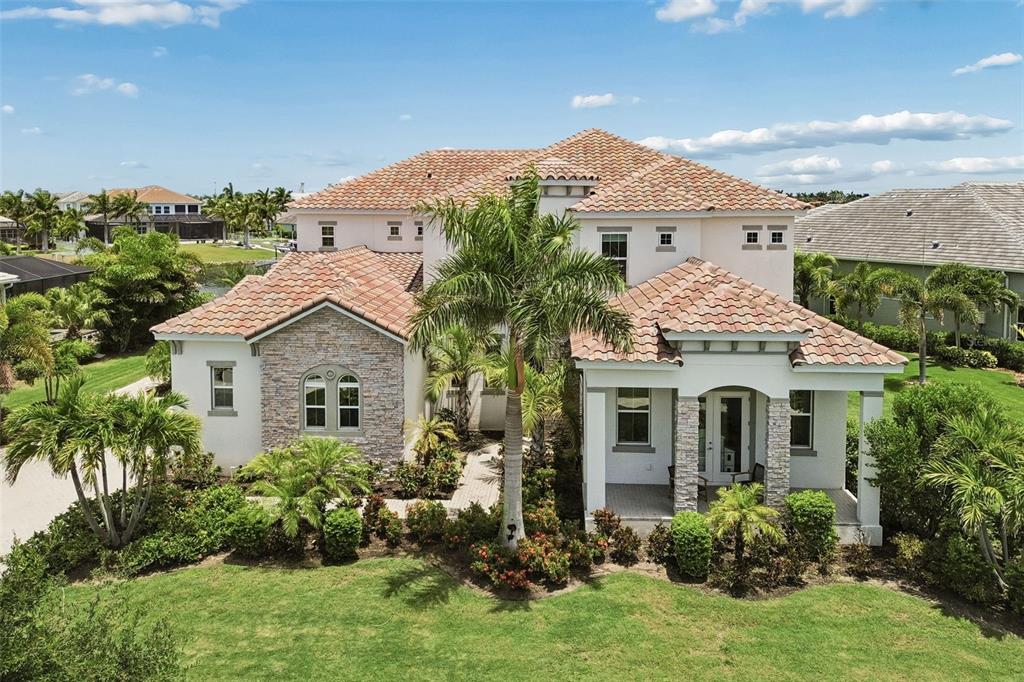 An aerial view shows waterfront houses with boat docks along a canal in a neighborhood — 823 MANNS HARBOR DRIVE, APOLLO BEACH, FL
