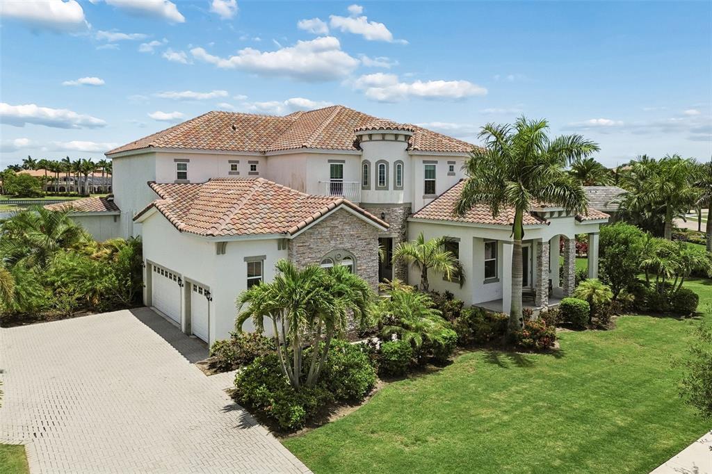 A screened-in pool and spa overlook a canal with a view of neighboring houses — 823 MANNS HARBOR DRIVE, APOLLO BEACH, FL