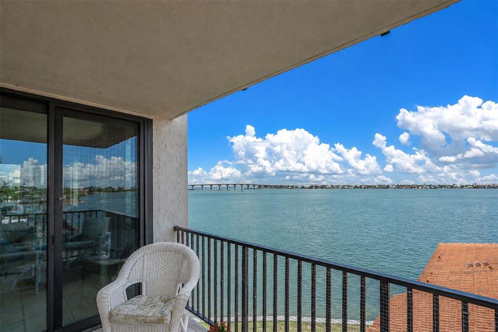 An entryway features tiled flooring, a white door, louvered closet doors, and two coastal-themed wall art pieces — 6287 BAHIA DEL MAR CIRCLE UNIT 401, ST PETERSBURG, FL