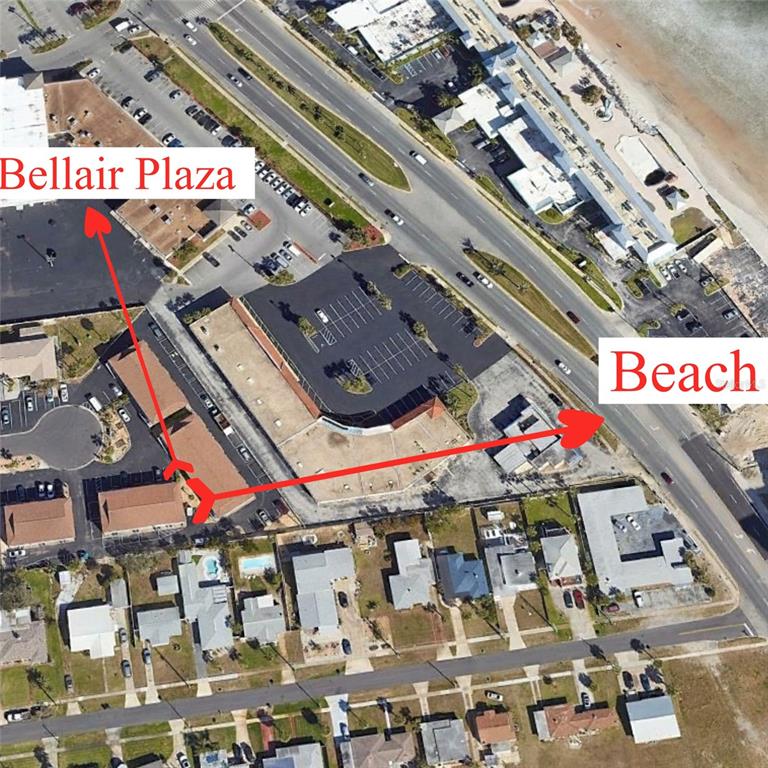 This aerial map shows a commercial plaza, parking lots, and nearby residential streets — 428 AUBURN DRIVE UNIT 202, DAYTONA BEACH, FL