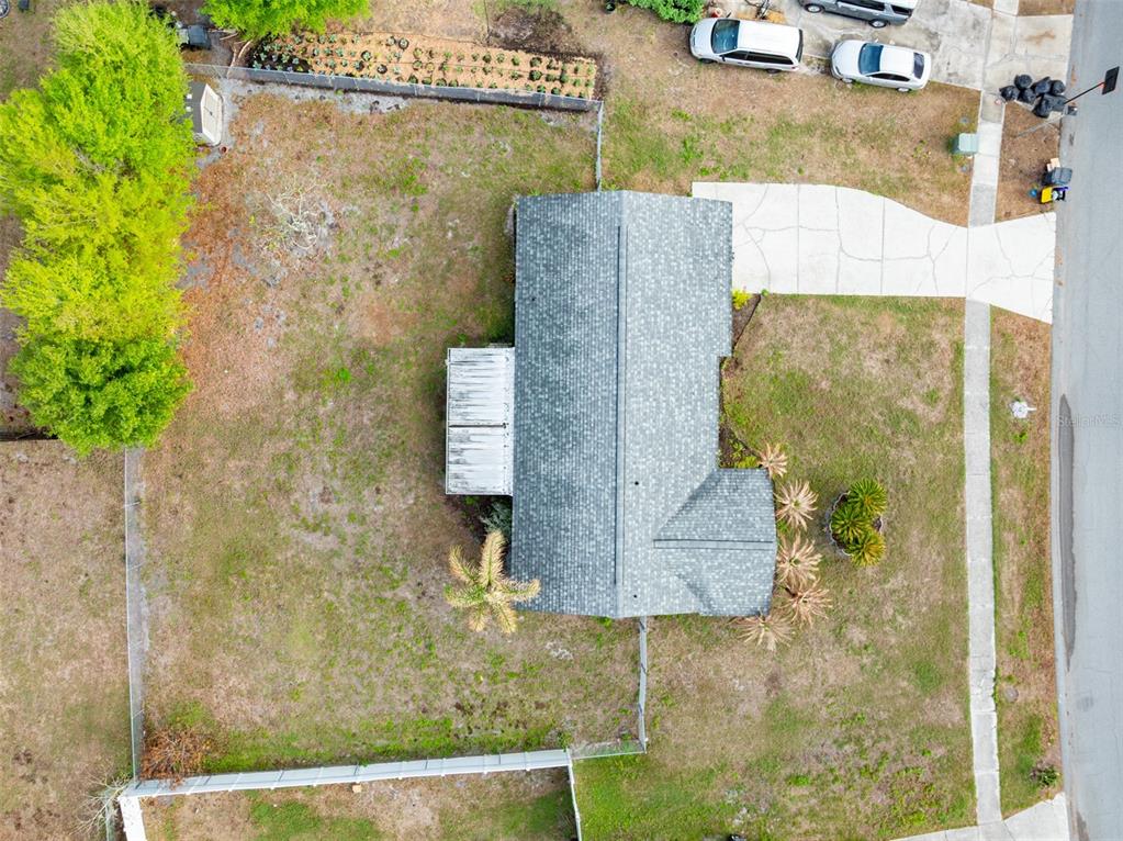 An aerial view shows a house with a gray roof, a driveway, and a fenced yard — 5067 BLACK BIRCH TRAIL, MULBERRY, FL
