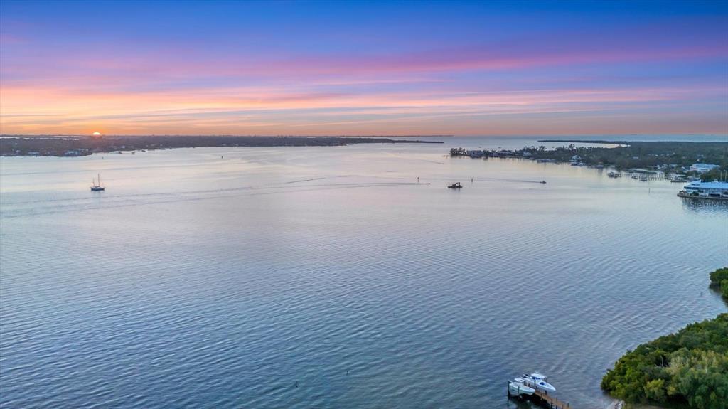 An aerial view of a calm bay at sunset with boats and a wooden dock — 3405 10TH STREET W, PALMETTO, FL
