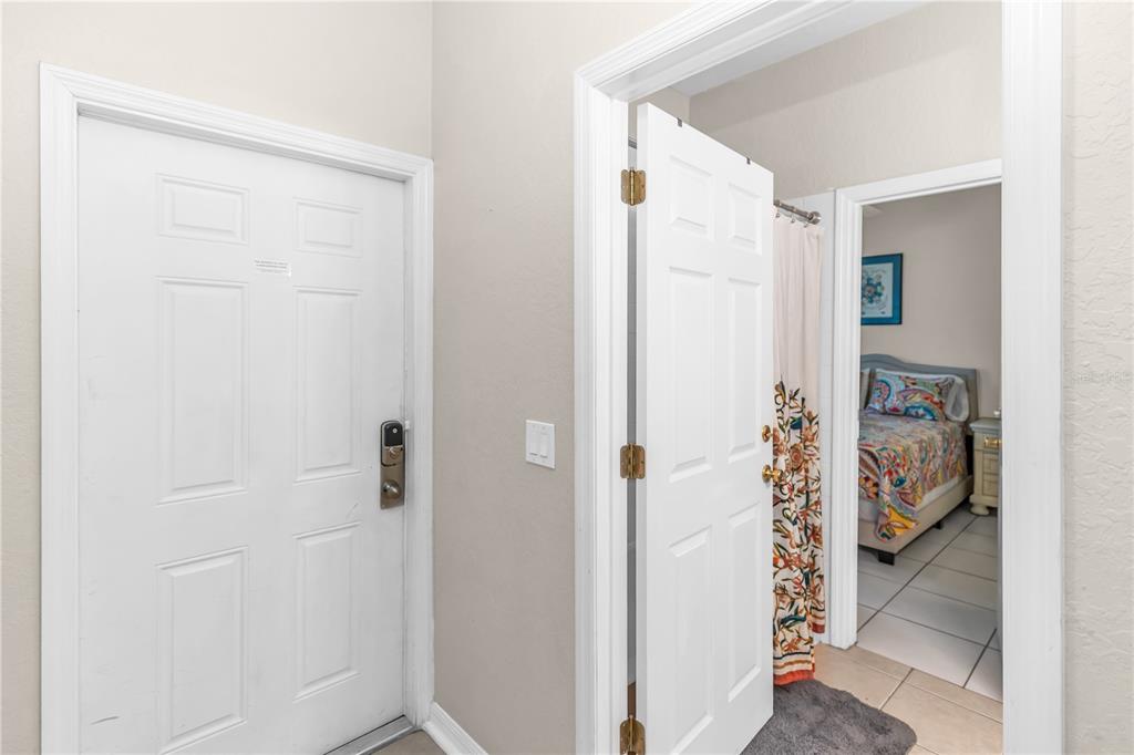 A white door stands next to an open doorway revealing a bathroom and a bedroom — 712 CALABRIA AVENUE, DAVENPORT, FL