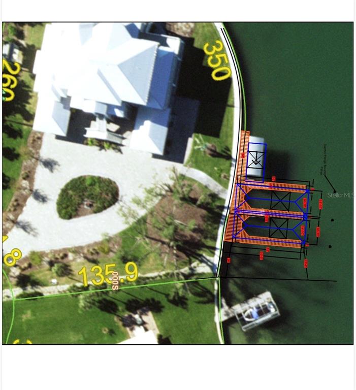 This is a site plan rendering showing a house, lawn, and a double boat slip dock — 565 GREEN DOLPHIN DRIVE S, PLACIDA, FL