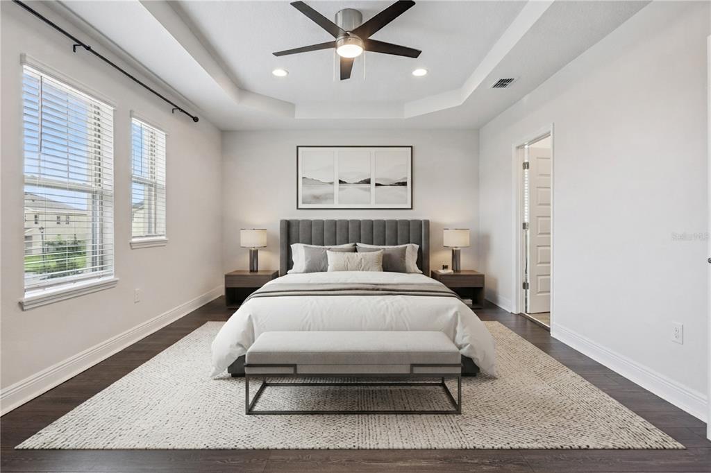 The rear exterior of a two-story house features a covered patio and a grassy lawn — 11031 JACKSON COVE, WINTER GARDEN, FL