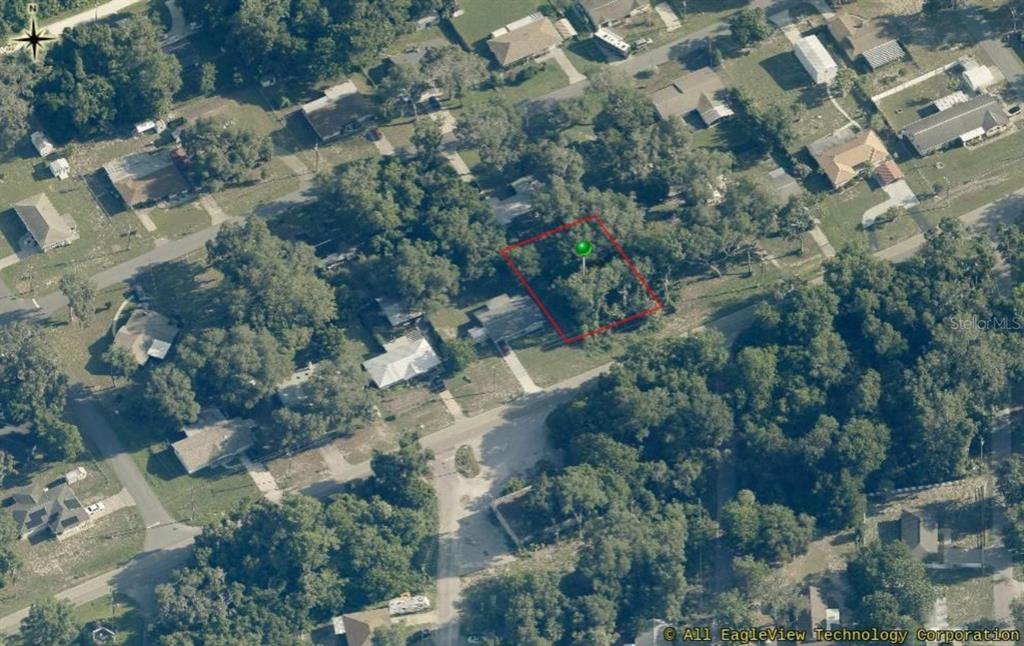 An aerial view shows a rectangular plot of land outlined in red within a neighborhood — 8731 E GOSPEL ISLAND ROAD, INVERNESS, FL