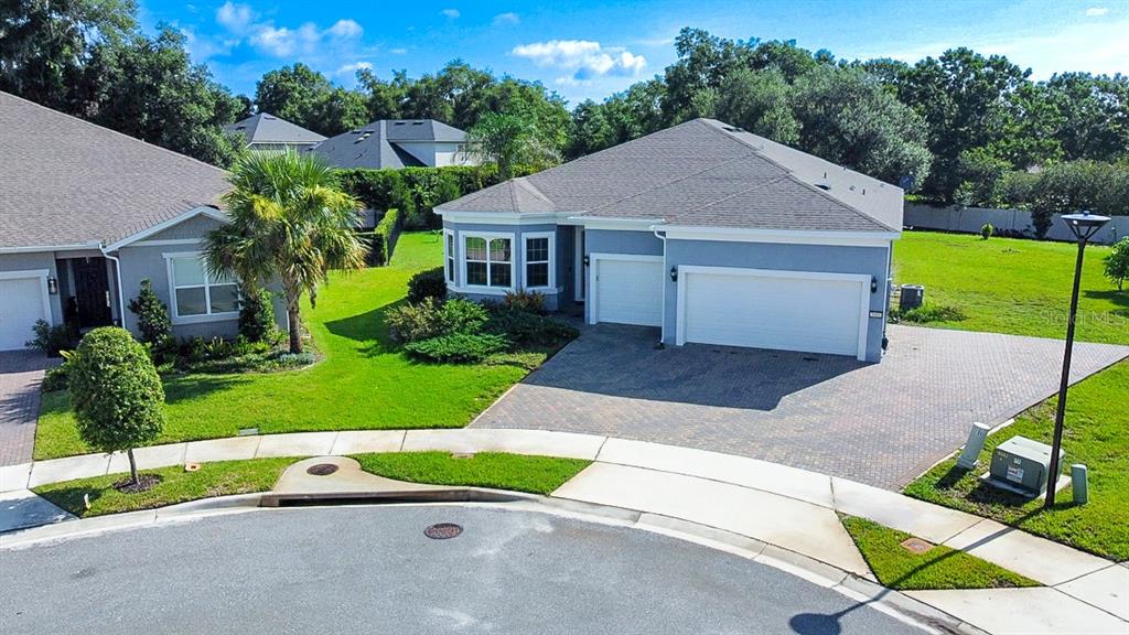 An aerial view of a suburban house with a gray exterior, paved driveway, and lawn — 3414 MICHIGAN STREET, LAKE MARY, FL