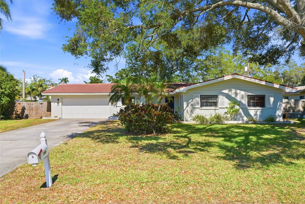 A single-story house with a red tile roof, white siding, and a two-car garage — 1349 VIEWTOP DRIVE, CLEARWATER, FL