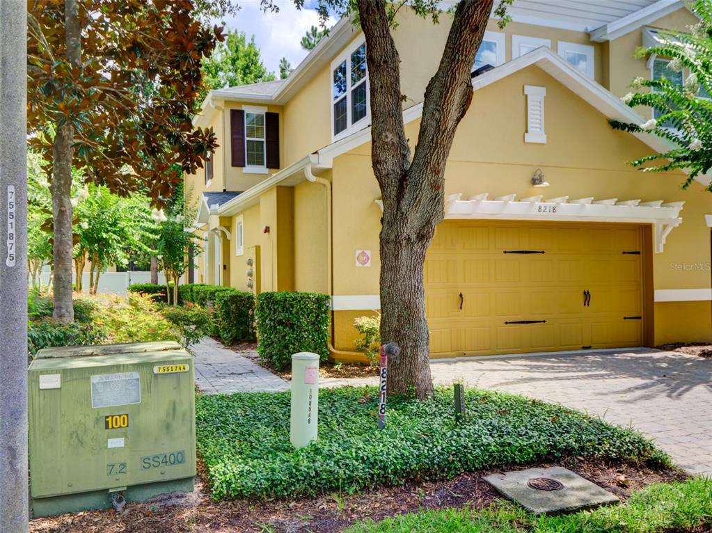 A two-story yellow house with a two-car garage and a paved driveway — 8218 MYSTIC VIEW WAY UNIT 2801, WINDERMERE, FL