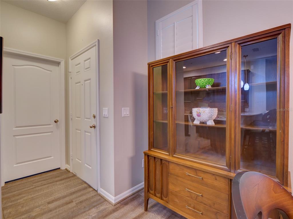 A wooden china cabinet stands in a room with light-colored walls and wood-look flooring — 8218 MYSTIC VIEW WAY UNIT 2801, WINDERMERE, FL