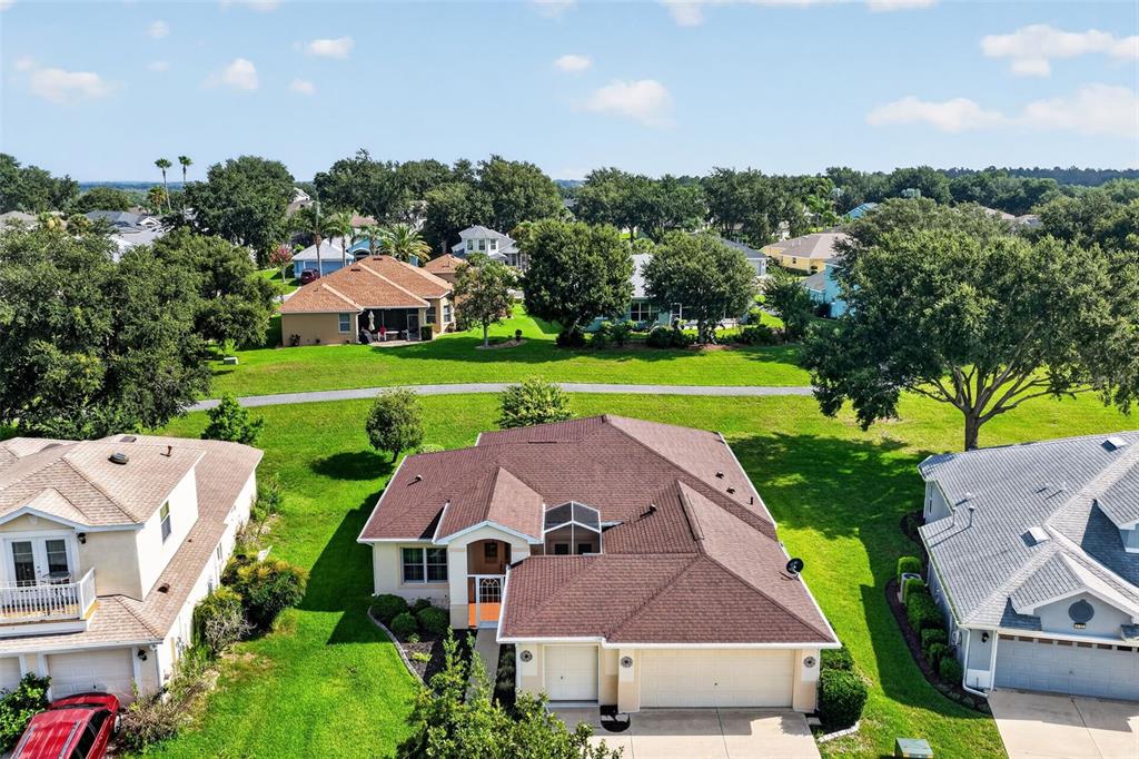 An aerial view shows a suburban house with a brown roof and a two-car garage — 5809 BOUNTY CIRCLE, TAVARES, FL