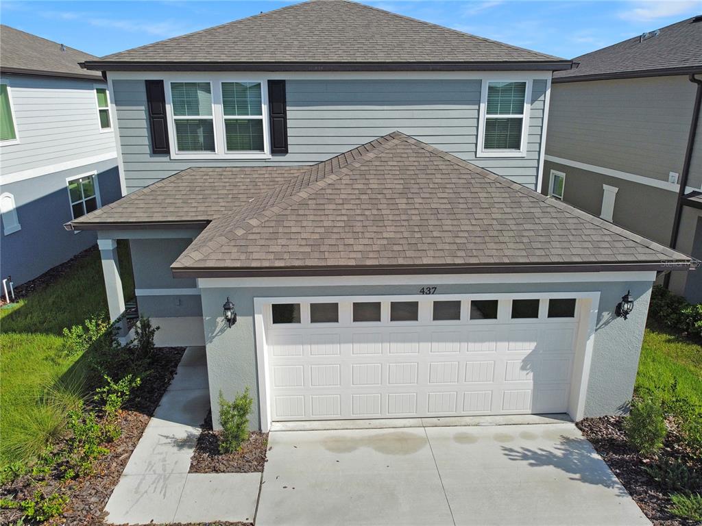 An aerial view of a two-story house with a light blue exterior and a garage — 437 WATERFORD DRIVE, LAKE ALFRED, FL