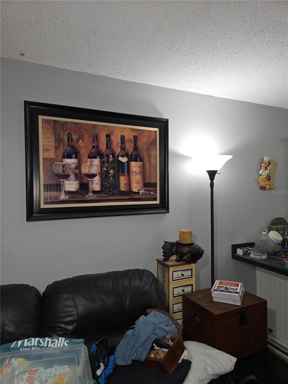 A kitchen features white cabinets, dark countertops, a white stove, and tiled flooring — 6400 46TH AVENUE N UNIT 305, KENNETH CITY, FL