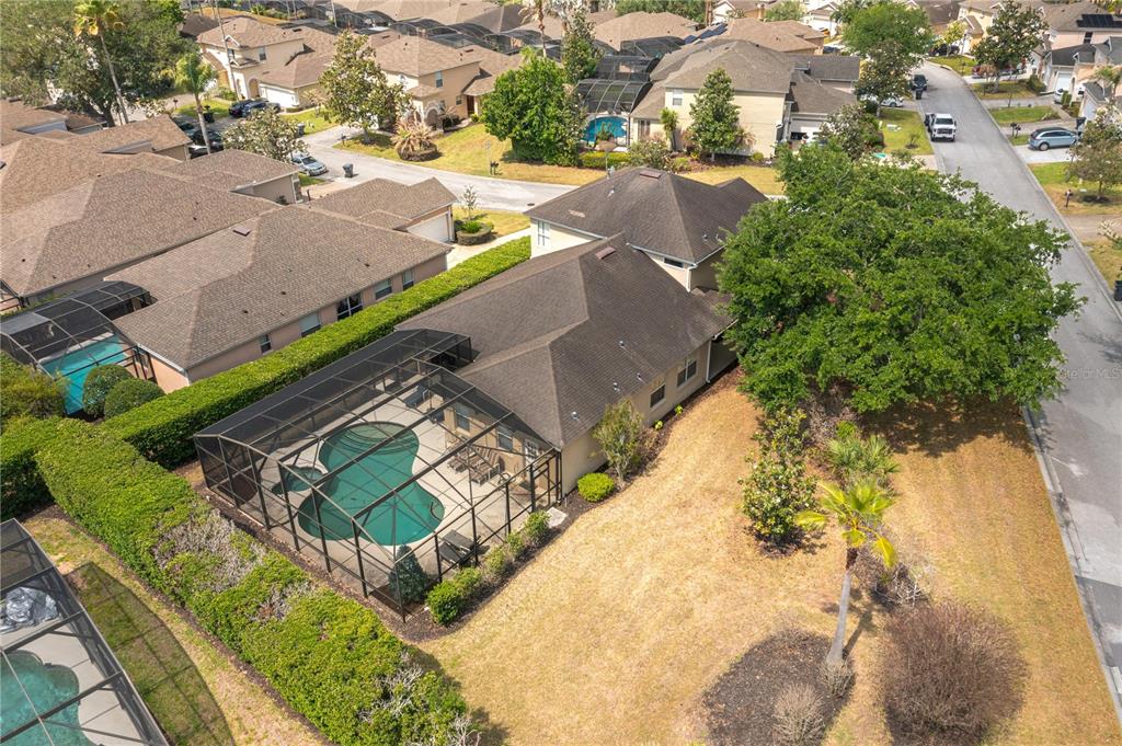 An aerial view shows a house with a screened-in pool and a large side yard — 106 SENECA LN, DAVENPORT, FL