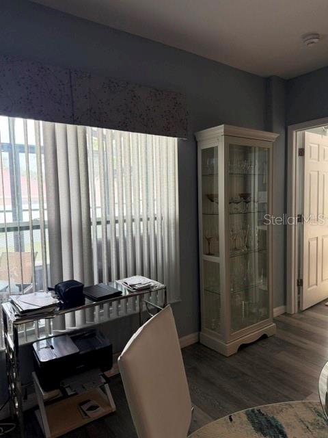 A room with a glass display cabinet, a metal desk with a printer, and vertical blinds — 9934 LENOX STREET, CLERMONT, FL
