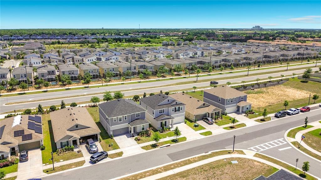 An aerial view shows several suburban houses with driveways and a road in a neighborhood — 795 OVERPOOL AVENUE, DAVENPORT, FL