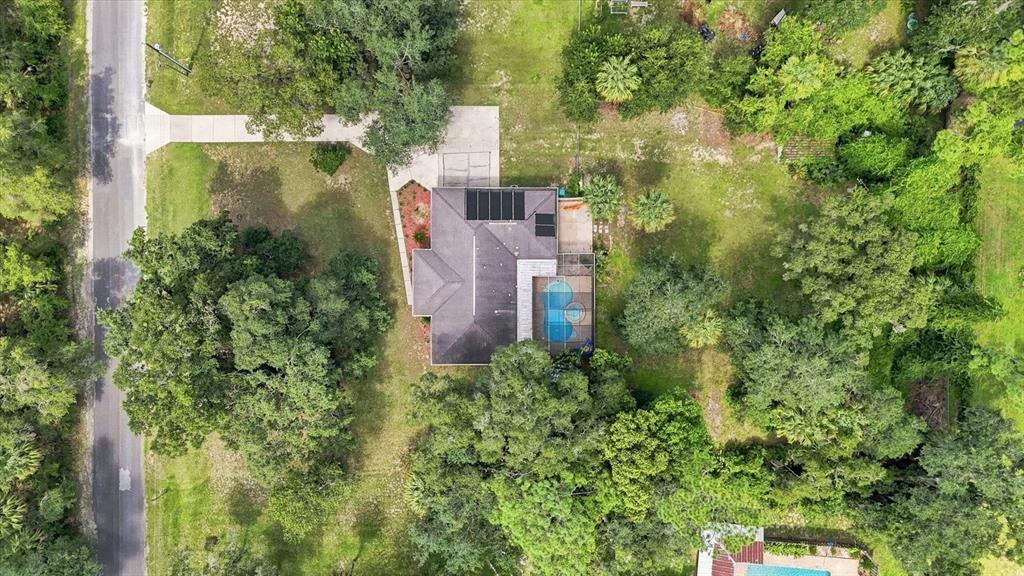 An aerial view shows a house with a pool, solar panels, and a driveway — 9685 W TOM MASON DRIVE, CRYSTAL RIVER, FL