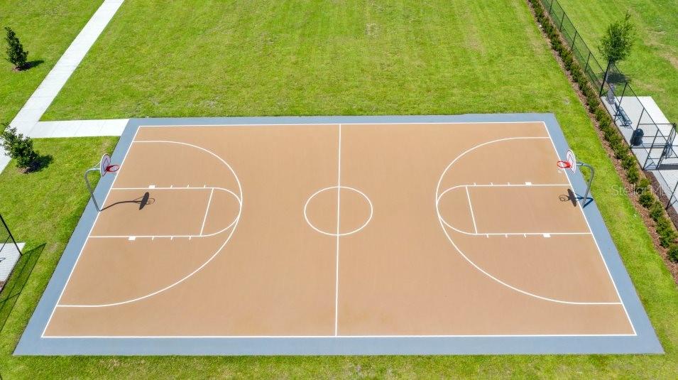 An aerial view shows an outdoor basketball court with a tan surface and white lines — 3873 AMERS LOOP, HAINES CITY, FL