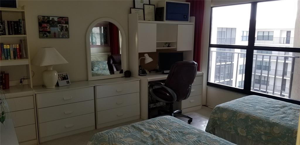 A bedroom features two beds, a white desk with a hutch, and a white dresser — 1001 BENJAMIN FRANKLIN DRIVE UNIT 701, SARASOTA, FL