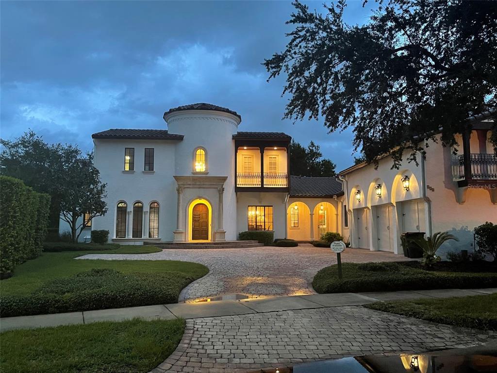 A two-story Mediterranean-style house with a circular tower, arched entryway, and a three-car garage — 234 ACADIA TERRACE, CELEBRATION, FL