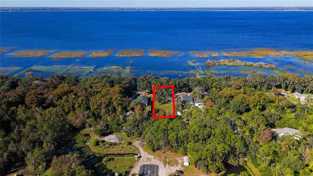 An aerial view shows a rectangular plot of land outlined in red near a lake — 0 LILLIAN BLACK ROAD, ST CLOUD, FL