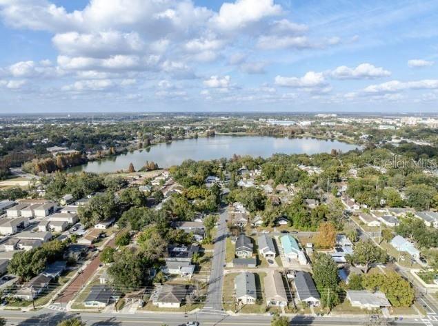 An aerial view shows a residential neighborhood situated along the shore of a large lake — 1225 KING AVENUE, LAKELAND, FL