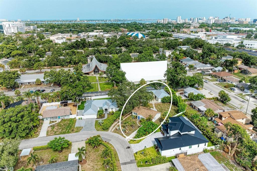 An aerial view of a single-story house with a gravel driveway and tropical landscaping — 1300 LOMA LINDA COURT, SARASOTA, FL