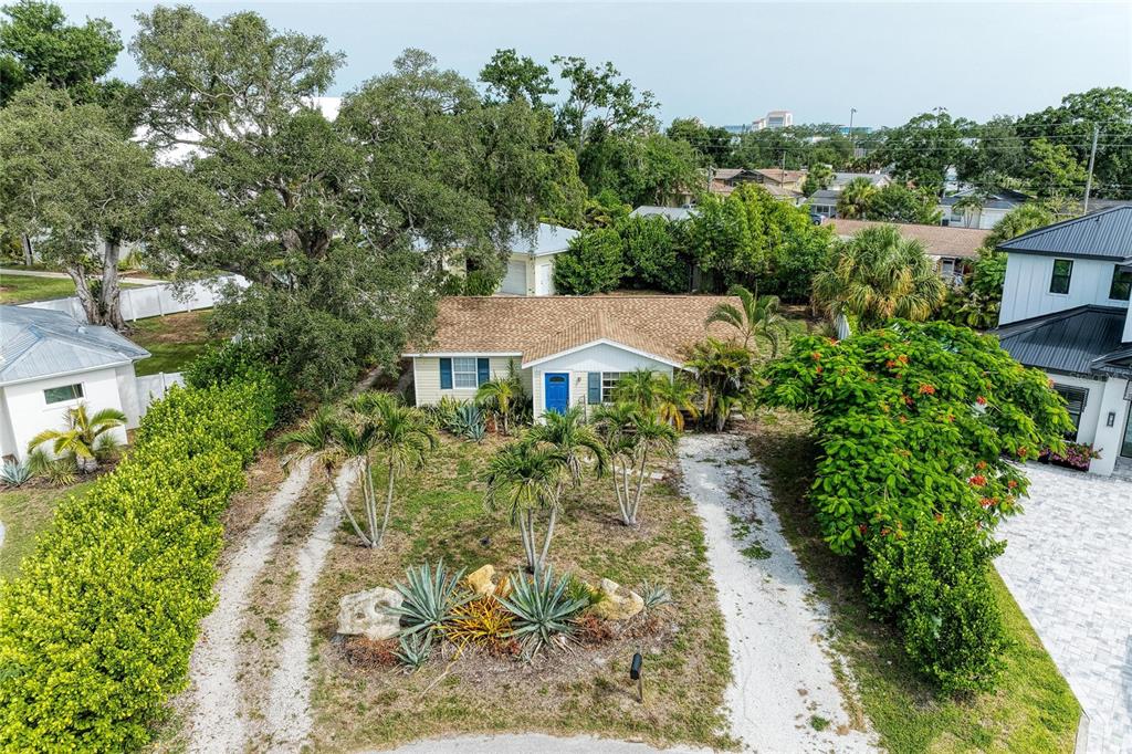 An aerial view shows two houses with a grassy yard and mature trees between them — 1300 LOMA LINDA COURT, SARASOTA, FL