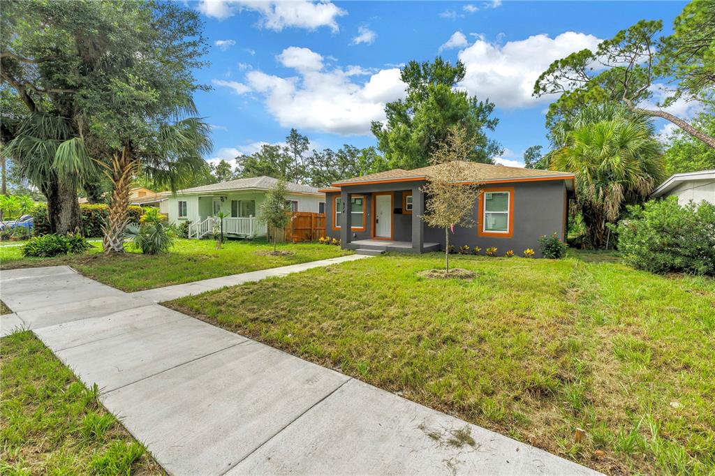 A gray house with a white garage door and wooden forms for a new driveway — 974 23RD AVENUE S, ST PETERSBURG, FL