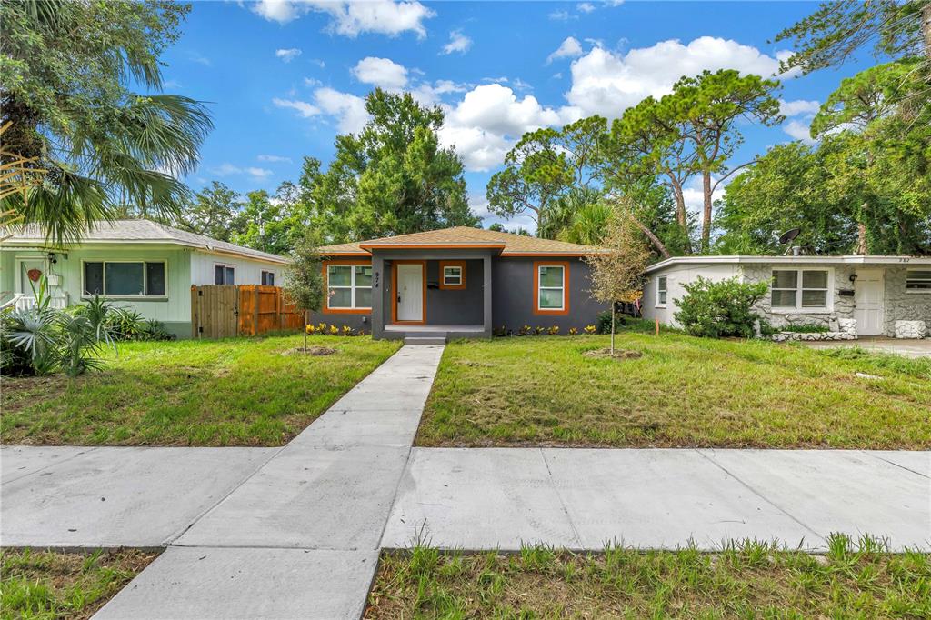 A single-story gray house with an orange roof trim and a concrete walkway — 974 23RD AVENUE S, ST PETERSBURG, FL