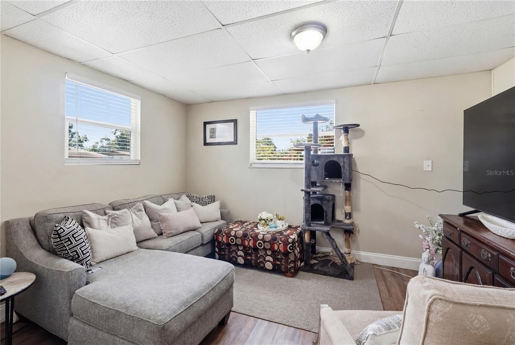 A dining area with a white table and chairs sits between two bedroom doorways — 1410 KOZART COURT, ORLANDO, FL