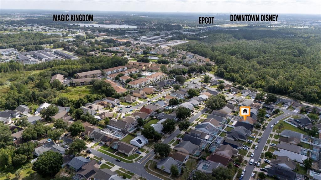 This aerial view shows a residential neighborhood with a highlighted house and distant theme parks — 8809 PARLIAMENT COURT, KISSIMMEE, FL