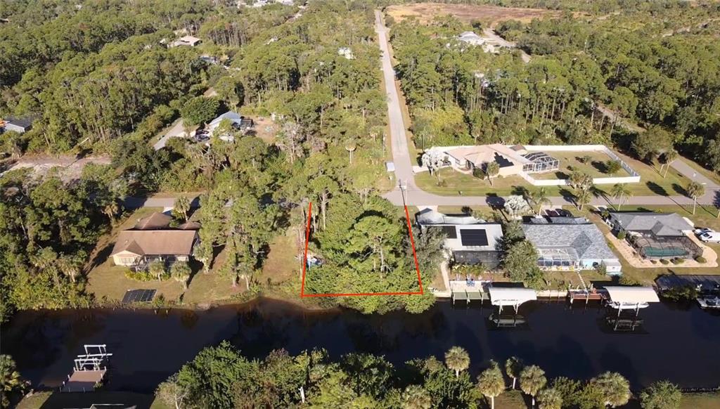 An aerial view shows a residential property with a house situated along a canal — 468 CORY STREET, PORT CHARLOTTE, FL