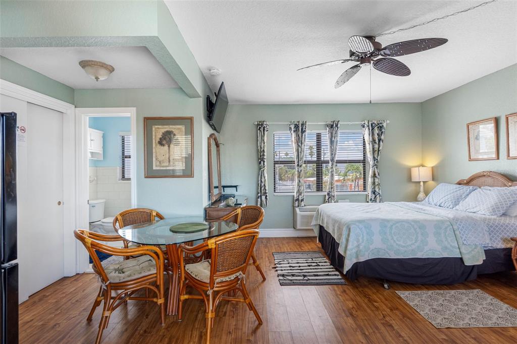 A hotel room features a dining table, a bed, and an attached bathroom — 16333 GULF BOULEVARD UNIT 210, REDINGTON BEACH, FL