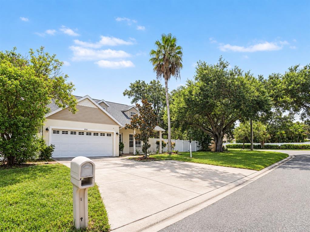 A single-story house with a white garage, a palm tree, and a concrete driveway — 3715 E 31ST STREET, BRADENTON, FL