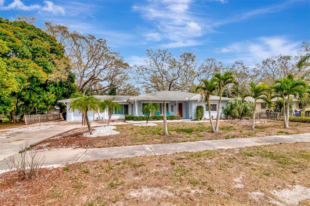 A single-story house with a light blue exterior, palm trees, and a concrete driveway — 305 BAKER AVENUE, CLEARWATER, FL