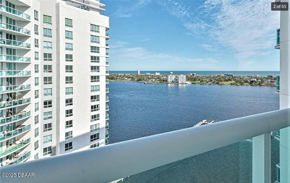 A high-rise balcony view overlooks a large body of water and a neighboring building — 231 RIVERSIDE DRIVE UNIT 2206, HOLLY HILL, FL