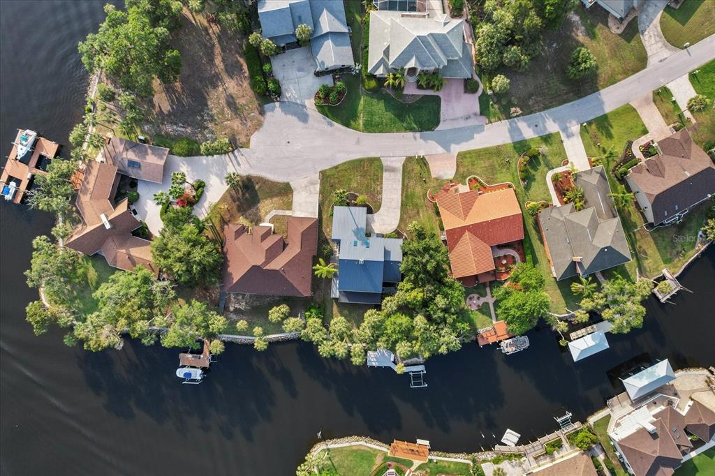 An aerial view shows waterfront houses with private docks along a winding canal — 5259 S STETSON POINT DRIVE, HOMOSASSA, FL
