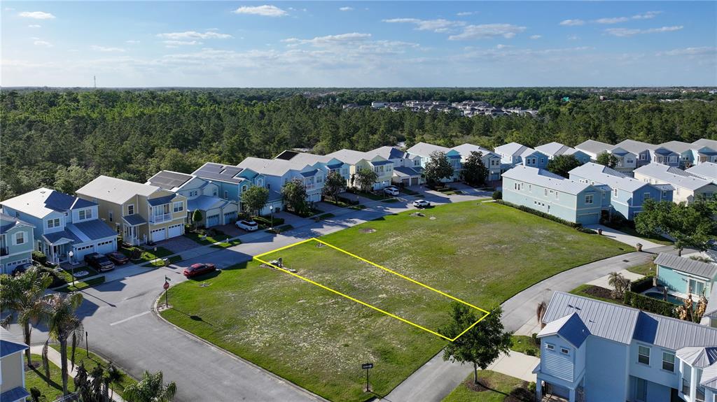An aerial view shows a vacant rectangular residential lot outlined in yellow within a neighborhood — FAIRVIEW CIRCLE, KISSIMMEE, FL