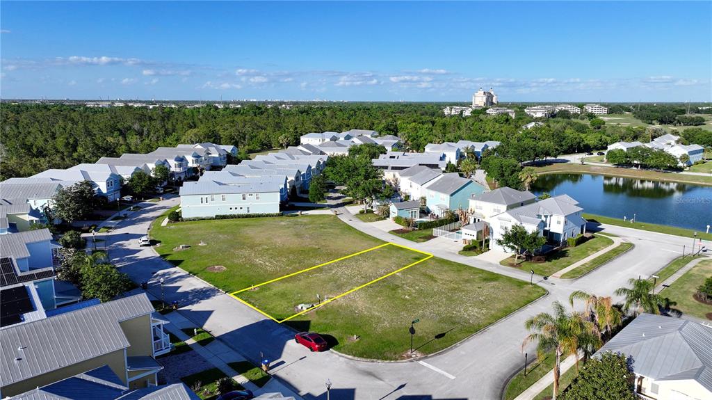 An aerial view shows a vacant residential lot outlined in yellow within a suburban neighborhood — FAIRVIEW CIRCLE, KISSIMMEE, FL