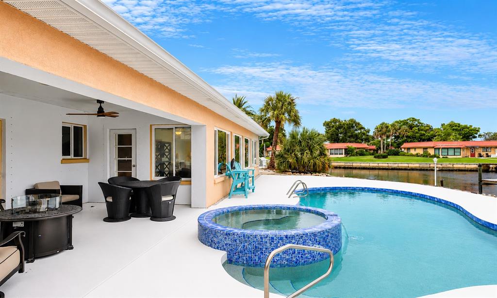 An aerial view shows a residential canal leading into Palma Sola Bay with numerous boat docks — 4223 ROYAL PALM DRIVE, BRADENTON, FL
