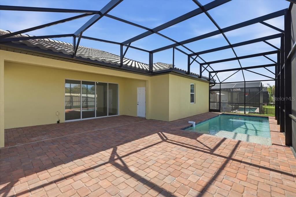 A single-story yellow house with a tile roof, two white columns, and a brick driveway — 363 VILLA SORRENTO CIRCLE, HAINES CITY, FL