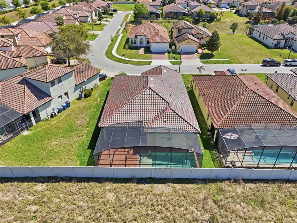 A screened-in patio features a brick paver floor and a small swimming pool — 363 VILLA SORRENTO CIRCLE, HAINES CITY, FL