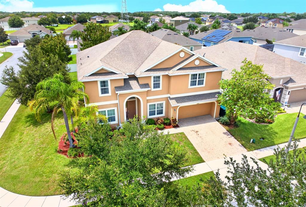 An aerial view of a two-story suburban house with a tan exterior and paved driveway — 12834 BOGGY VIEW DRIVE, ORLANDO, FL