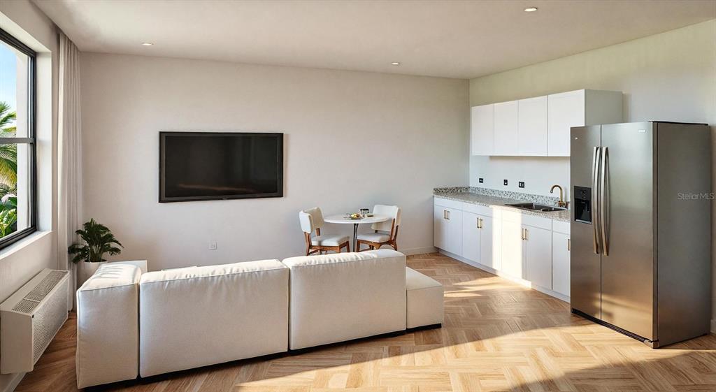 This studio apartment features a kitchenette, a dining area, and a white sectional sofa — 34 GREEN CIRCLE UNIT 102, PALM COAST, FL