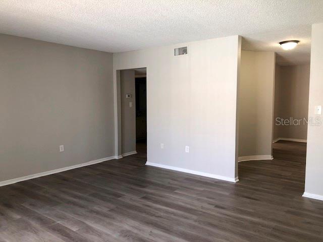 An empty room with light gray walls and dark wood-look flooring — 548 ORANGE DRIVE UNIT 14, ALTAMONTE SPRINGS, FL