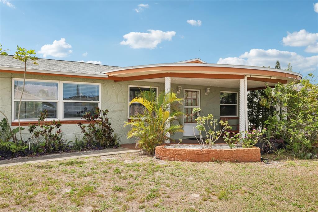 A single-story house with a garage, a curved front porch, and a light green exterior — 3548 DARLINGTON ROAD, HOLIDAY, FL