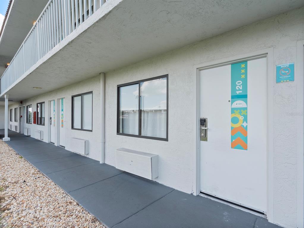 An exterior view of a motel-style building with a row of doors and windows — 5367 W IRLO BRONSON MEMORIAL HIGHWAY UNIT 1-120, KISSIMMEE, FL
